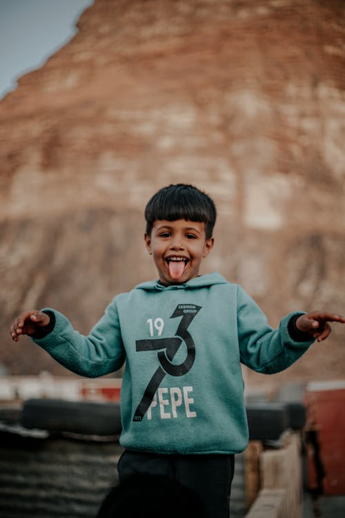 Close-up Photo of Boy with his Tongue Out 