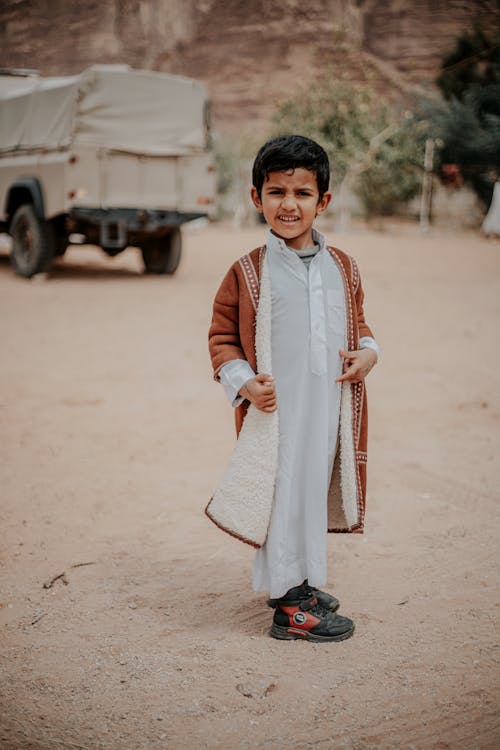 Photo of a Boy Standing on a Road 