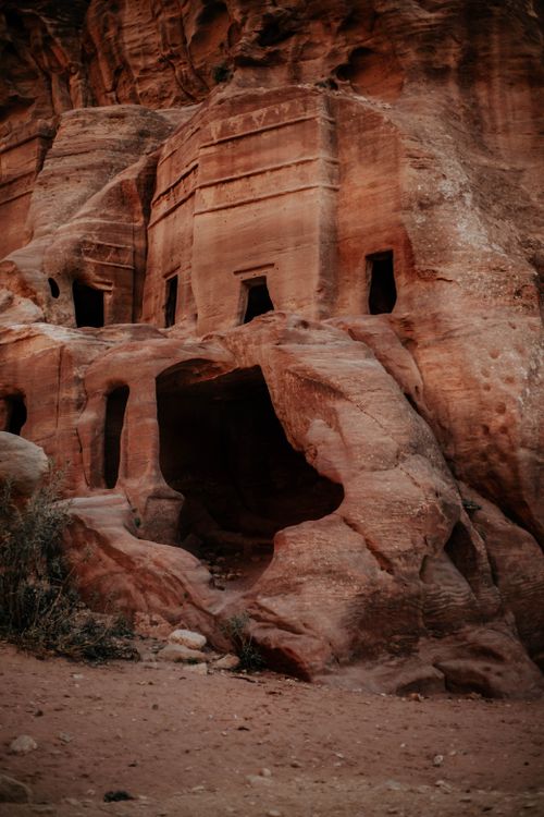 Free Explore the intricate ancient rock-cut structures within this captivating sandstone formation. Stock Photo