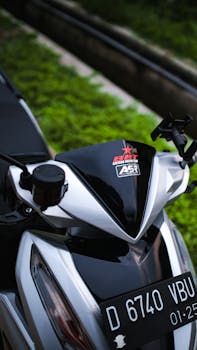 Detailed close-up of a modern motorcycle with visible license plate and handlebar design.