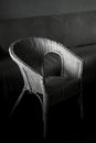 White Wicker Armchair on Gray Couch