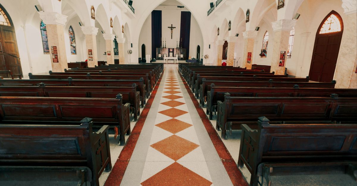 Interior of EP Church Ho Bankoe with wooden pews and stained glass