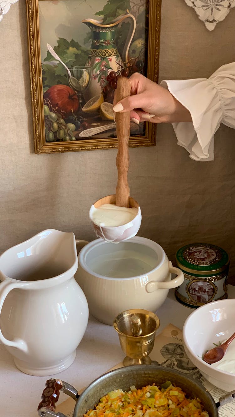 A Person Holding A Wooden Ladle