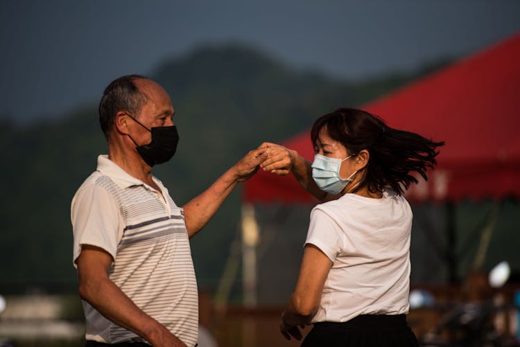 Adult Couple Dancing In Medical Masks
