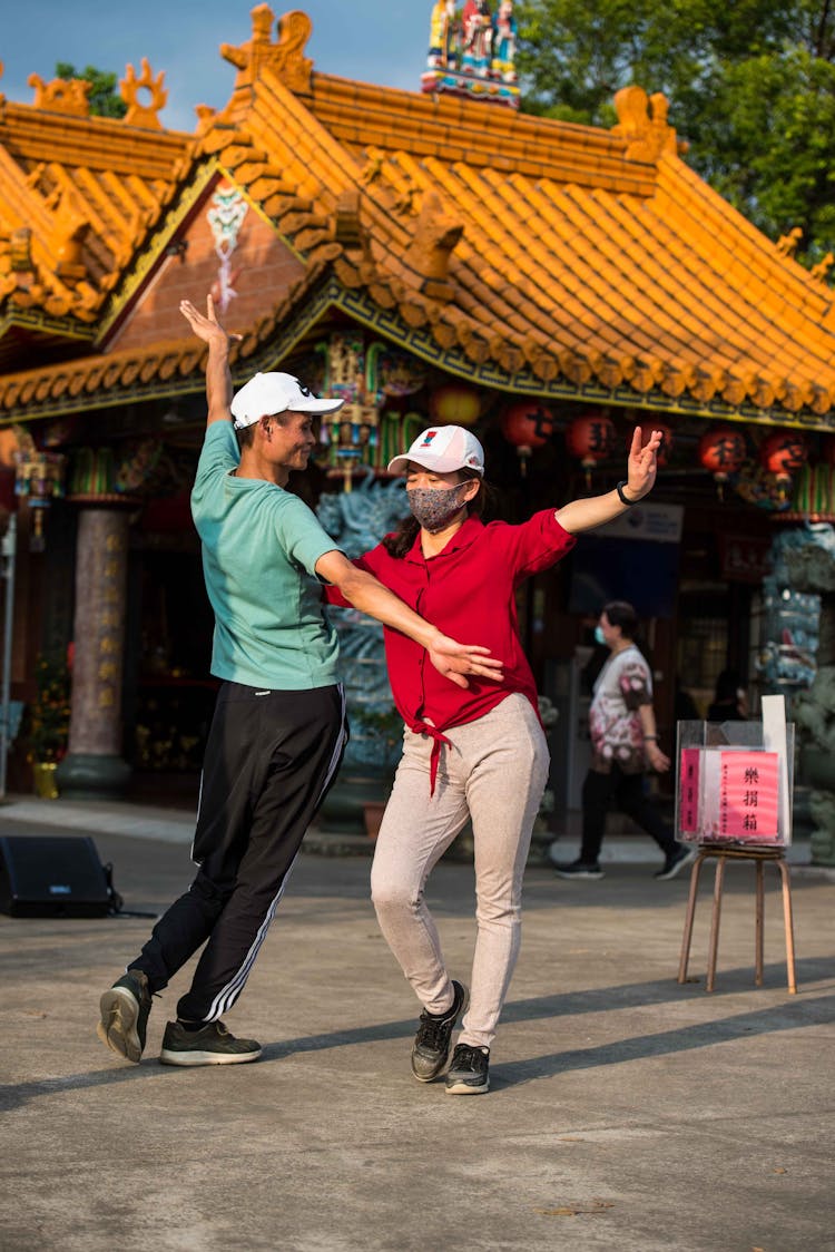 Happy Couple Dancing On City Street