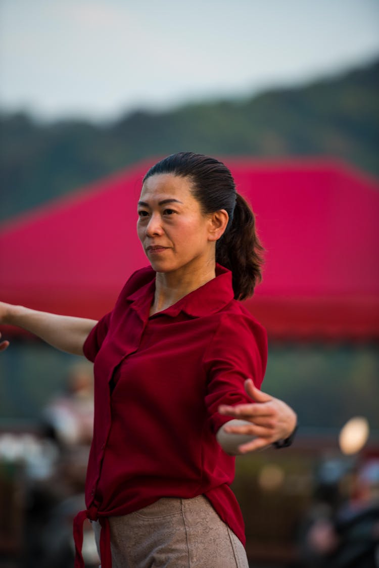 A Woman In Red Polo Shirt Dancing