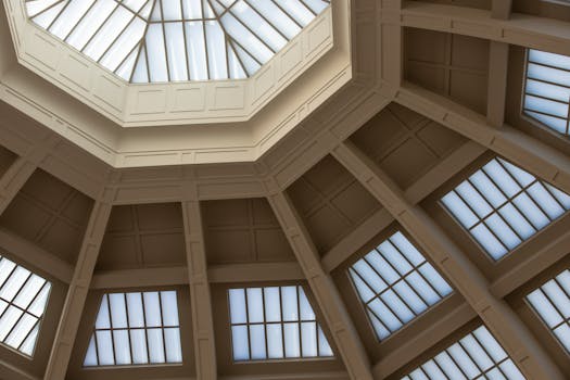 Low angle view of a modern geometric ceiling featuring skylights