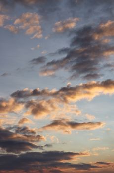 Beautiful cloud formation in a blue sky during sunset, creating a golden hour effect.