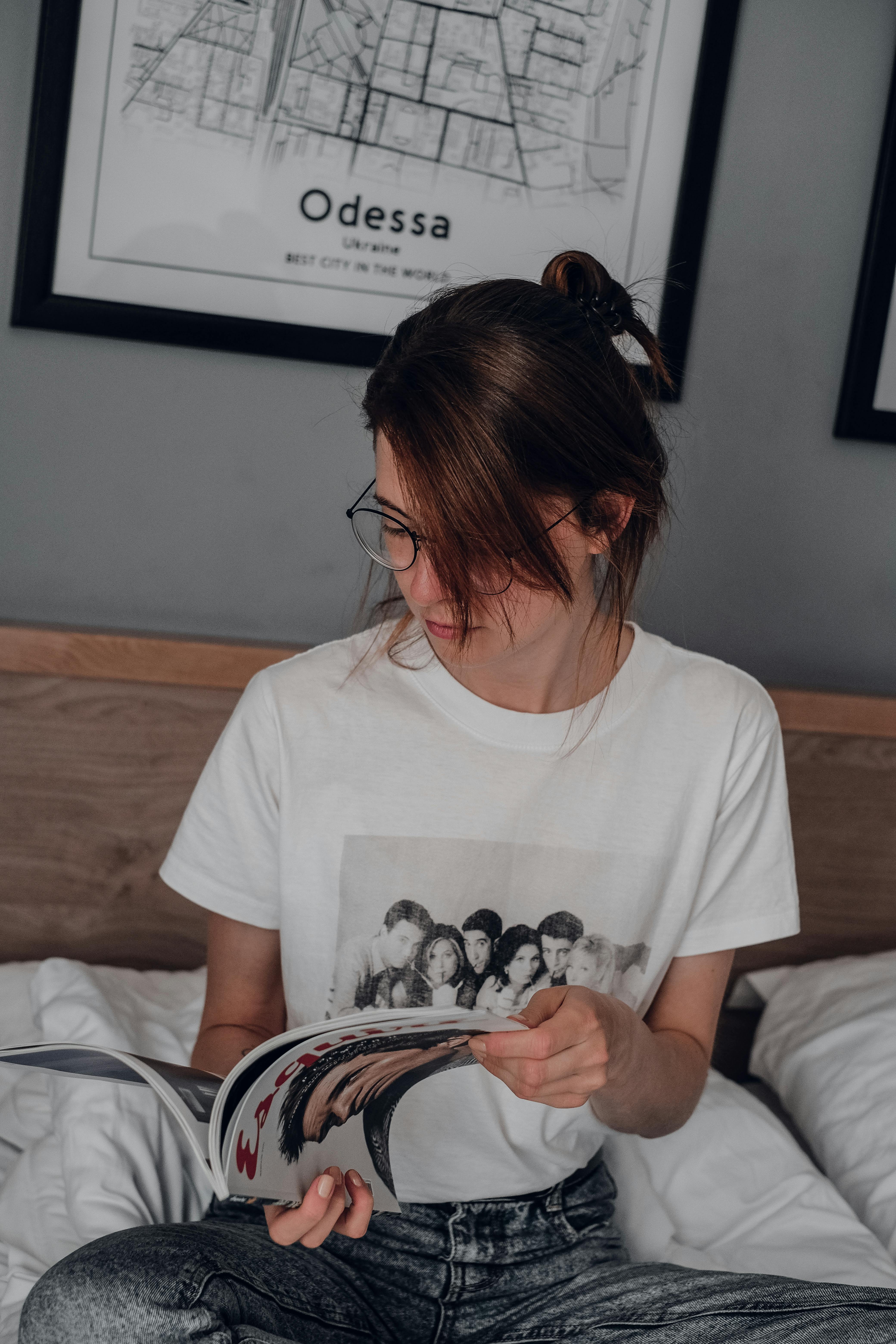 woman in white crew neck t shirt holding black and white bag