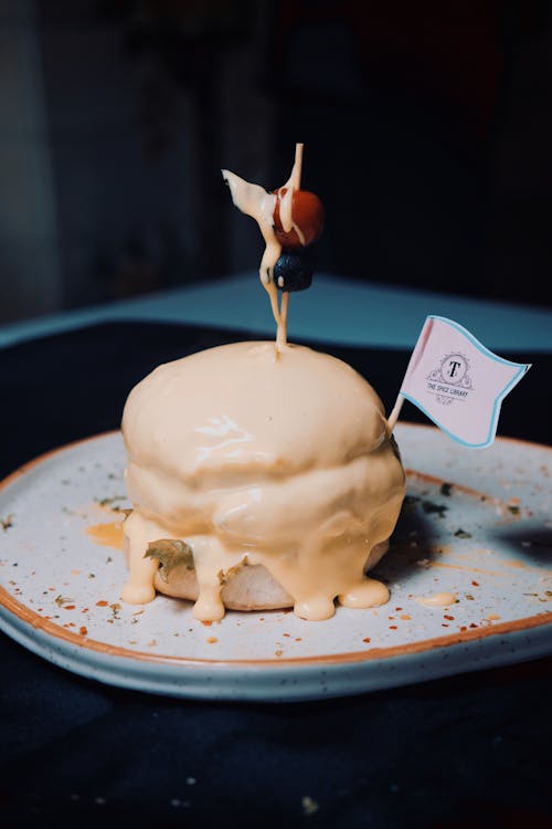 A Burger with Red and Black Berries Topped with Cheese Melt