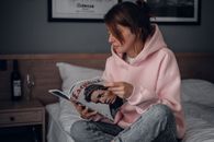 Woman in Pink Hoodie Holding Smartphone