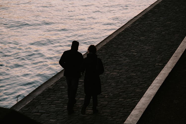 Couple Walking Together On Pier