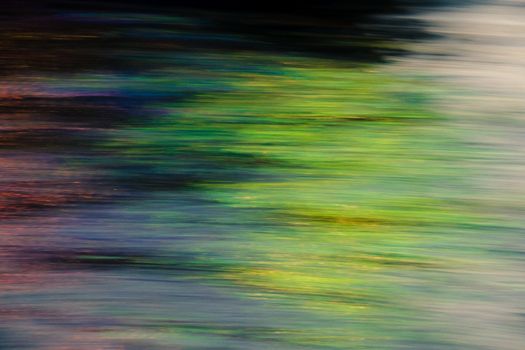 Colorful streaks of light blend in an abstract motion blur, creating a dynamic and vibrant effect.