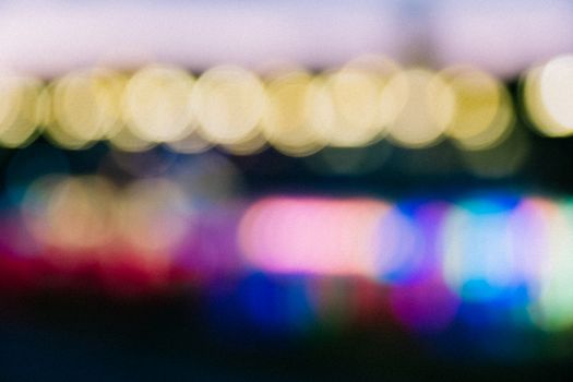 A vibrant abstract image featuring colorful bokeh lights in defocused style for creative use.