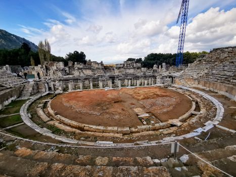 Stunning view of ancient Roman amphitheater ruins under a bright sky, showcasing historical architecture.