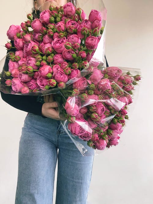 Woman Carrying Bouquet of Roses