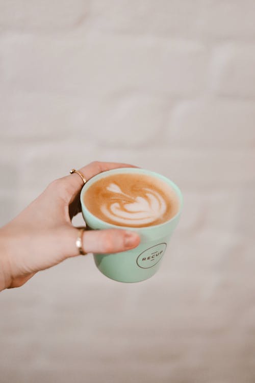 Free Person Holding Green Ceramic Mug With Coffee Stock Photo