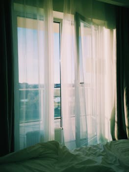 Flowing White Curtains over Open Balcony Door 