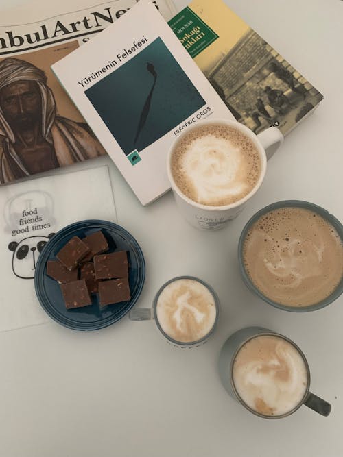 Cappuccino in White Ceramic Mug Beside White Book