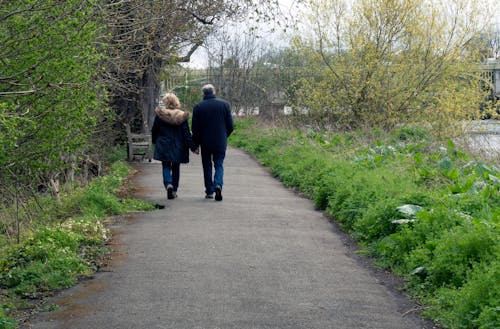 Back View of a Couple Walking Hand in Hand