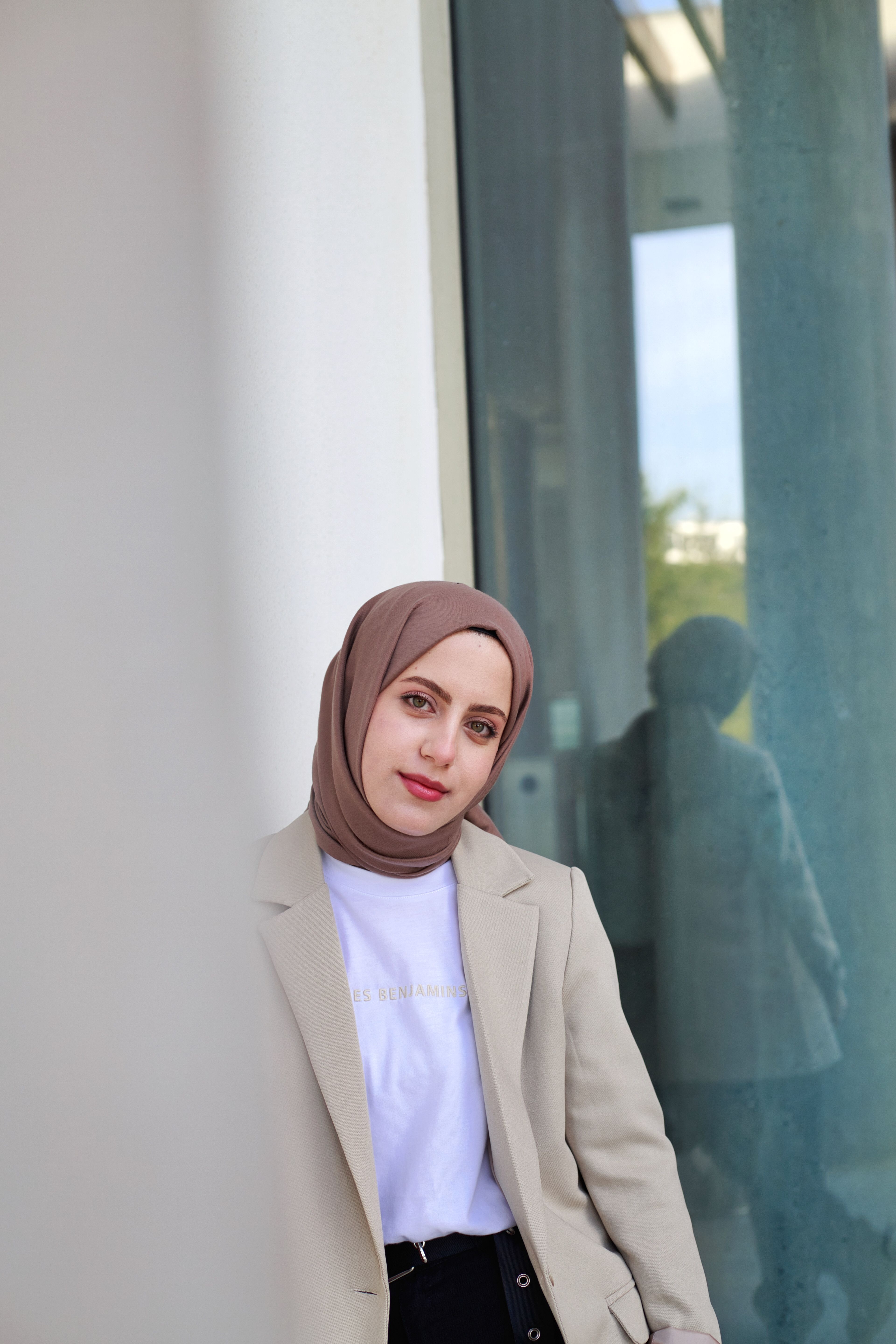 Woman in Brown Hijab Standing Near Glass Window · Free Stock Photo