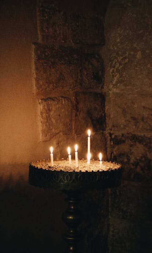 Lighted Candles on Black Round Stand 