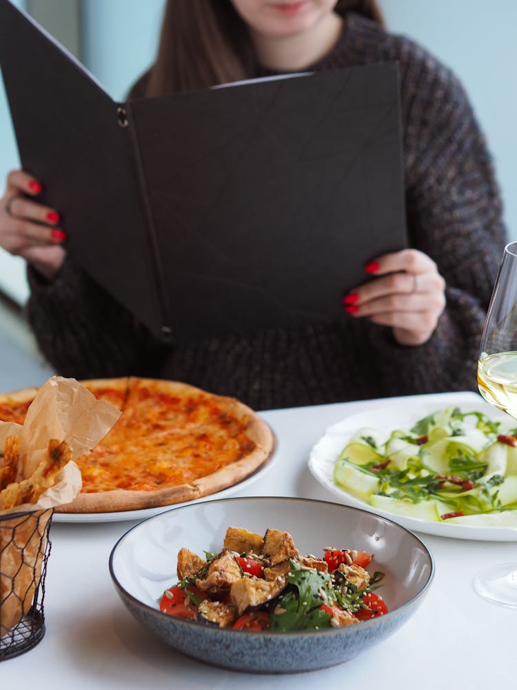 Pizza And Salads For Lunch In Restaurant