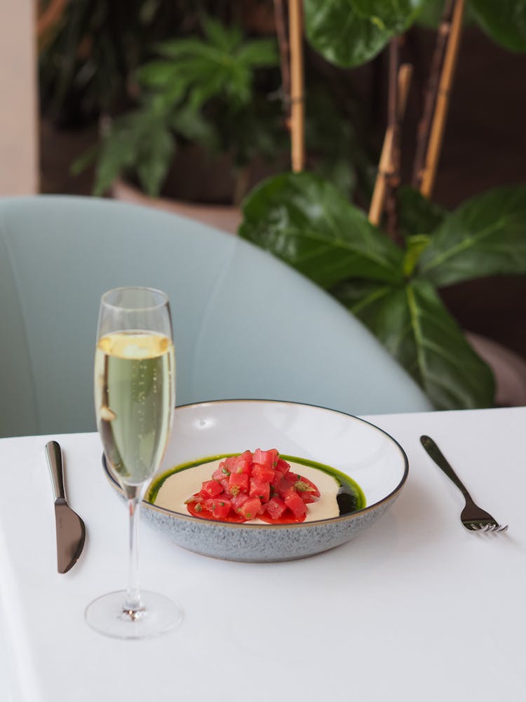 Red Diced Tomato Salad And Glass Of White Wine