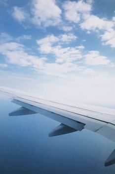 View of an airplane wing soaring above a clear blue sky, perfect for travel themes.