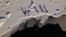 People Hiking on Snow Covered Mountain