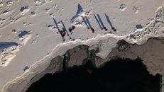 People Standing on Snow Covered Mountain