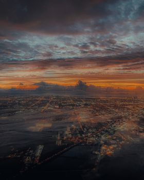 Breathtaking aerial view of Miami's urban landscape under a dramatic sunset sky.