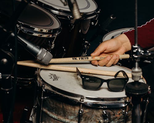 Close-up Photo of Drumsticks held by a Drummer