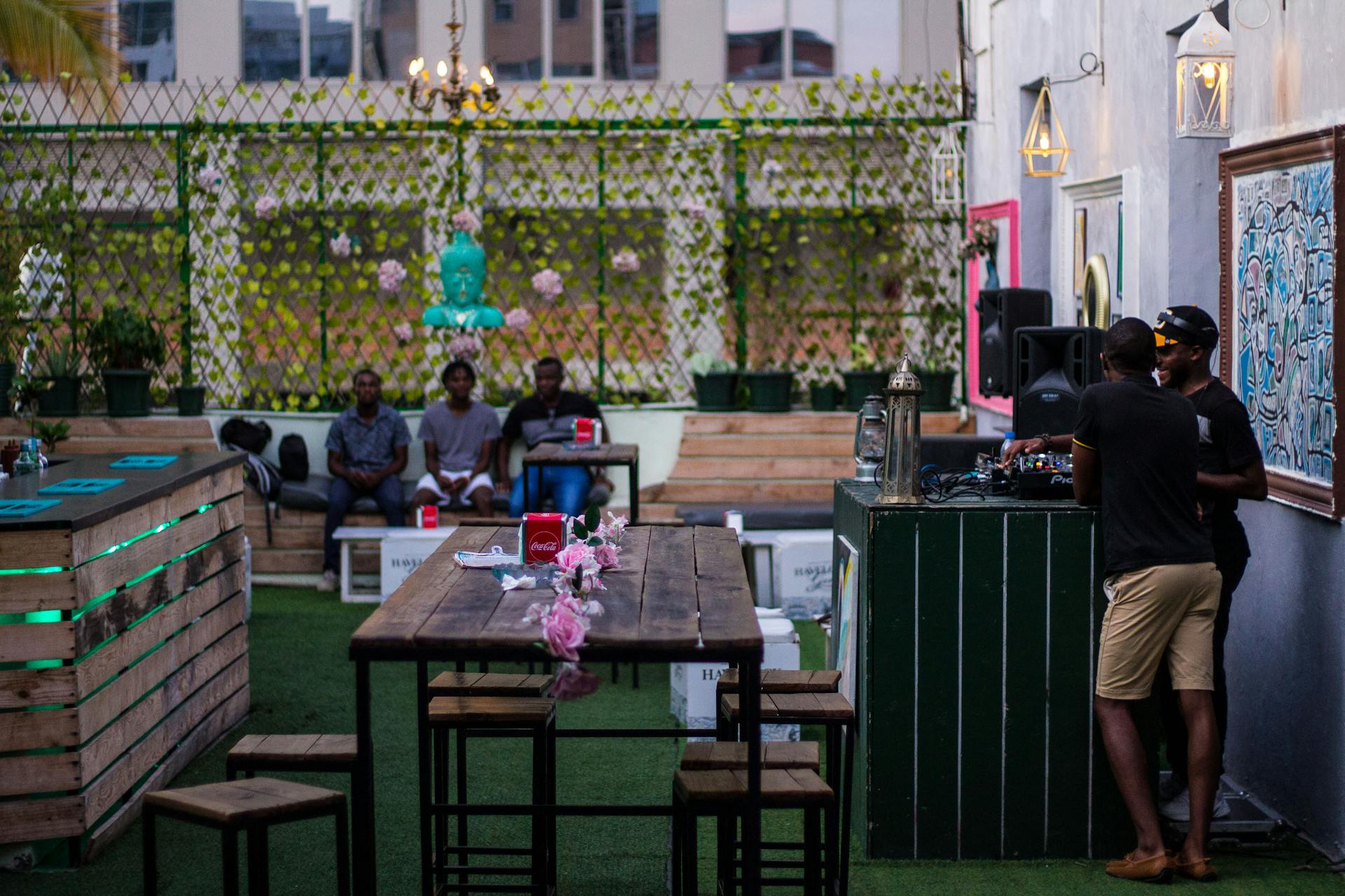 A vibrant outdoor bar in Luanda with people relaxing and enjoying the ambiance.