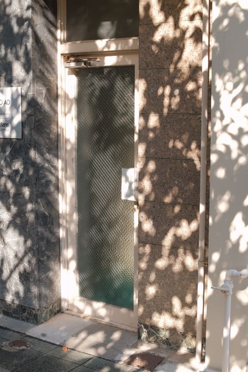 Free Artistic sunlight and shadows on a textured door entrance. Stock Photo