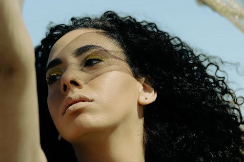 Portrait of a Beautiful Woman with Curly Black Hair