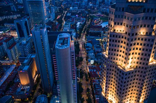 Free Stunning aerial view of Singapore's skyline at night, showcasing illuminated skyscrapers and city lights. Stock Photo