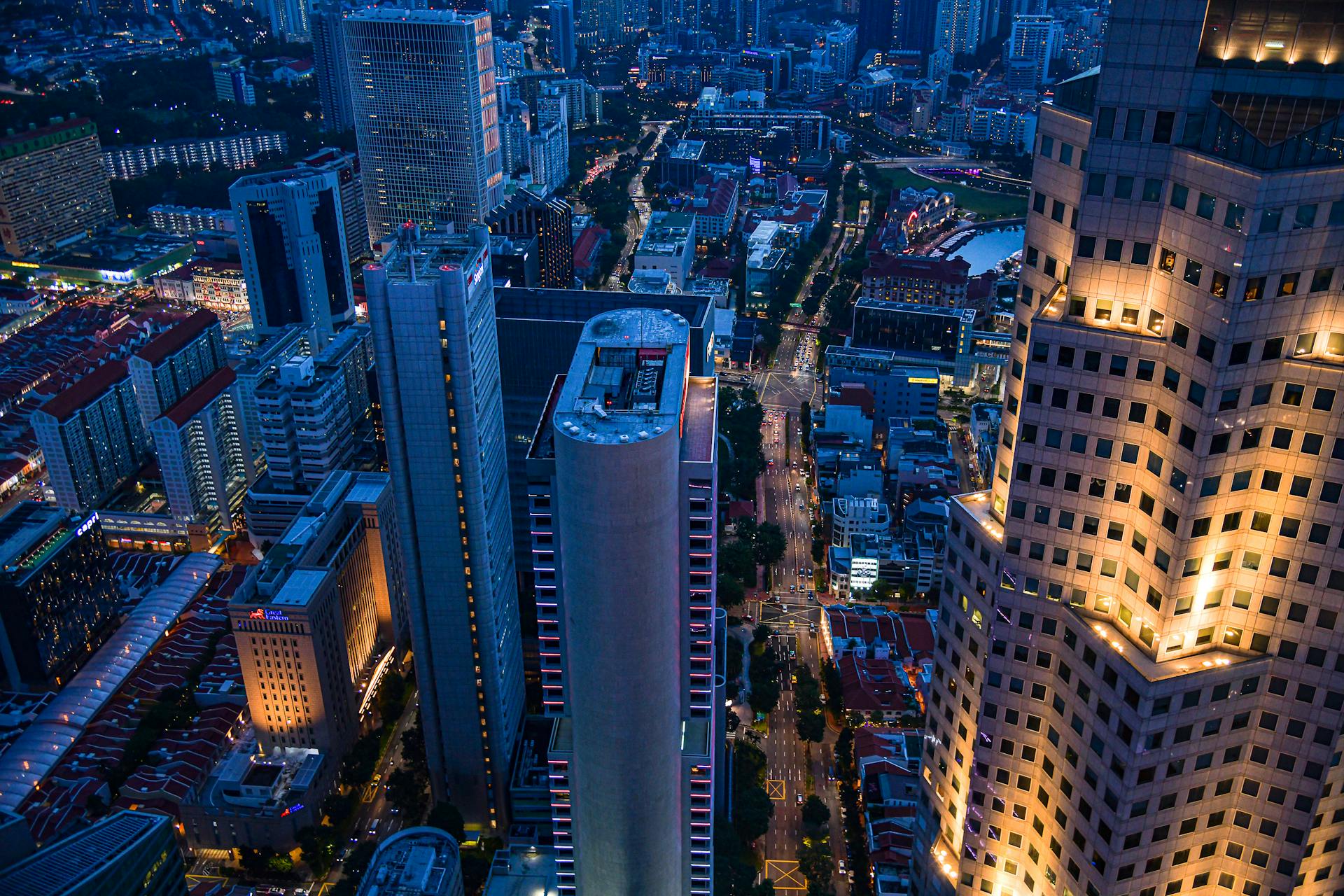 Explore the vibrant cityscape of Singapore from above, capturing the lively urban vibe at night.