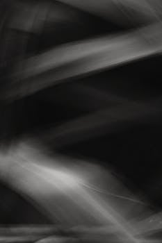 Artistic black and white abstract photo with dynamic light streaks.