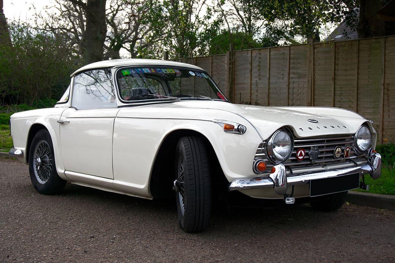 elegant white triumph sports car showcased outdoors embodying vintage