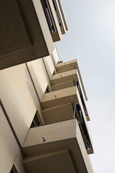 Low-angle view of a modern apartment building's exterior with balconies.