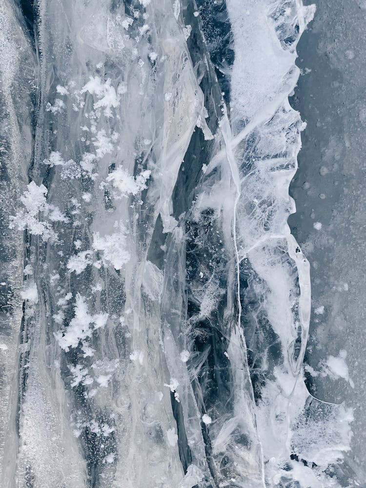 Snow Flakes Over Ice In Close-up Shot