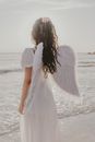 A Woman in White Dress Standing on Beach