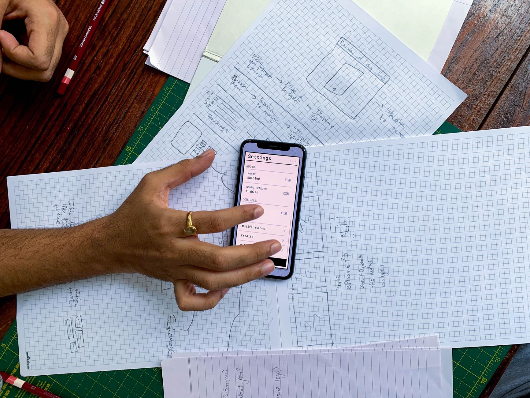 App development team reviewing mobile interface designs