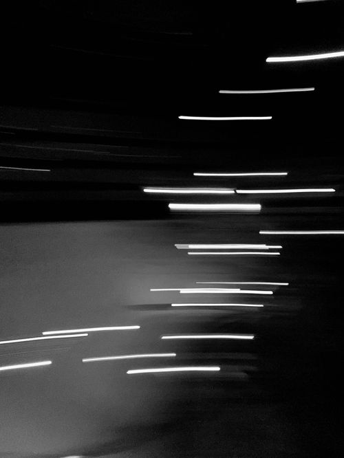 Free Abstract black and white image with dynamic light streaks creating motion and texture. Stock Photo