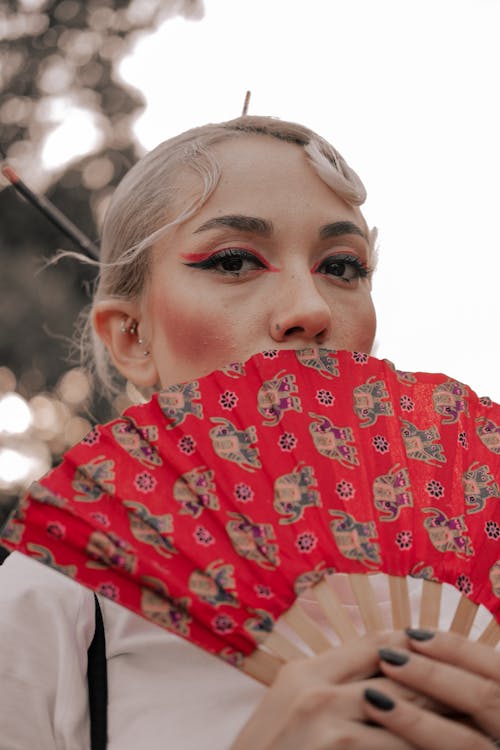 A Woman Holding a Fan