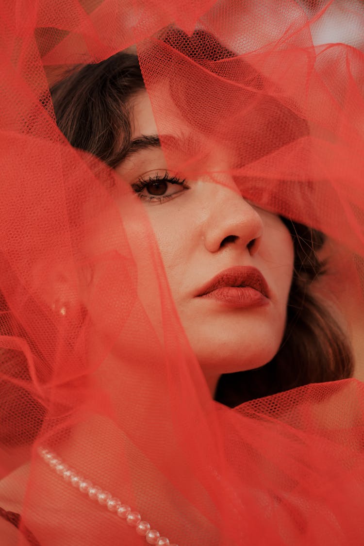 Woman With Red Fabric Around Face