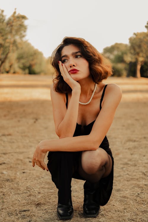 Woman Crouching on Ground