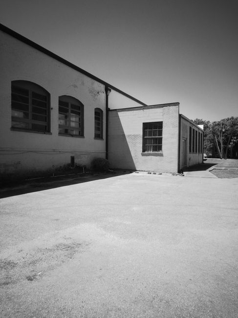 Monochrome image of a historic industrial building exterior in Sanford, FL, showcasing architectural design.