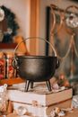 A Black Steel Pot over Deck of Boots